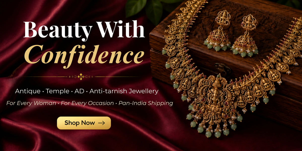 Gold-toned traditional Indian jewelry set including a necklace, earrings, and a wooden box, displayed on a dark red satin fabric background with promotional text reading 'Beauty With Confidence' and a 'Shop Now' button.